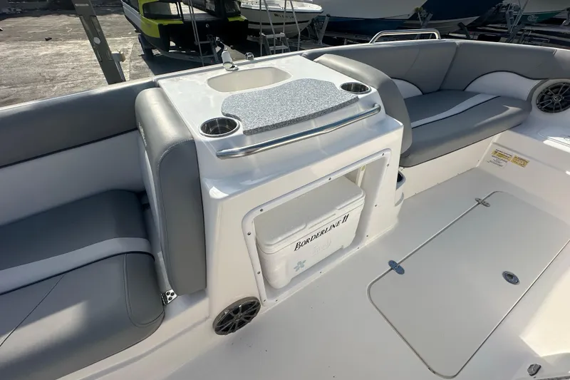 Slide: The Image of 2022 NauticStar 203 SC boat interior with seating and storage area. - 14