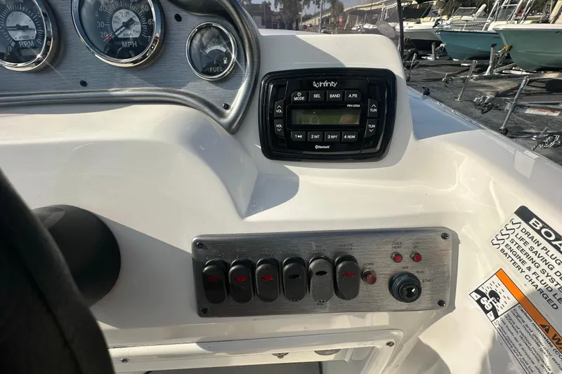 Slide: The Image of Dashboard of 2022 NauticStar 203 SC boat with gauges and control panel. - 22