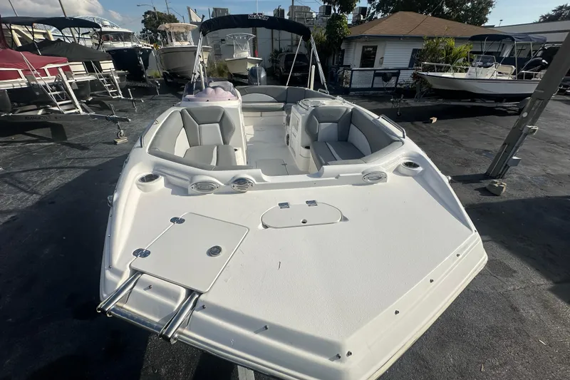 Slide: The Image of 2022 NauticStar 203 SC boat with spacious seating, docked outdoors. - 8