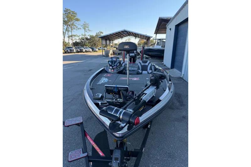 Slide: The Image of 2018 Ranger Z520L boat with dual axle trailer, metallic finish, parked on asphalt. - 7