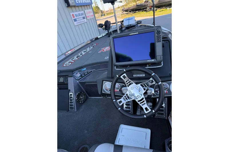 Slide: The Image of 2018 Ranger Z520L boat parked outdoors, equipped with fishing gear and electronics. - 9