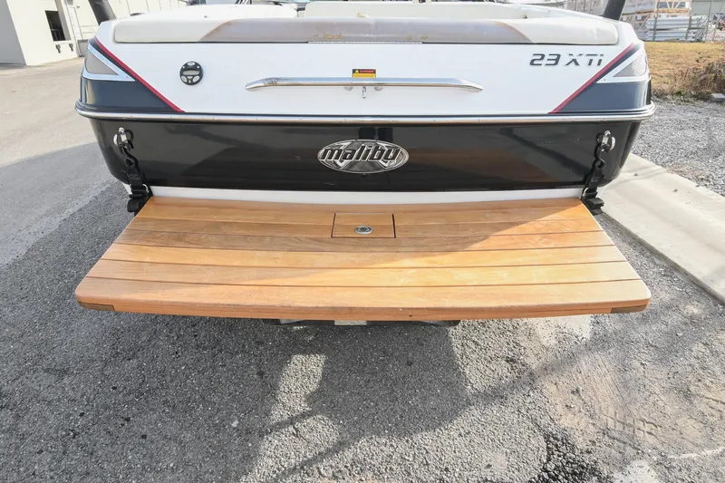 Slide: The Image of Rear view of 2004 Malibu Wakesetter 23 XTi boat with wooden swim platform. - 12