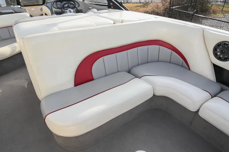 Slide: The Image of 2004 Malibu Wakesetter 23 XTi interior with white and red cushioned seating. - 17