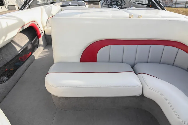 Slide: The Image of 2004 Malibu Wakesetter 23 XTi interior with white and red seating, showcasing luxury design. - 18