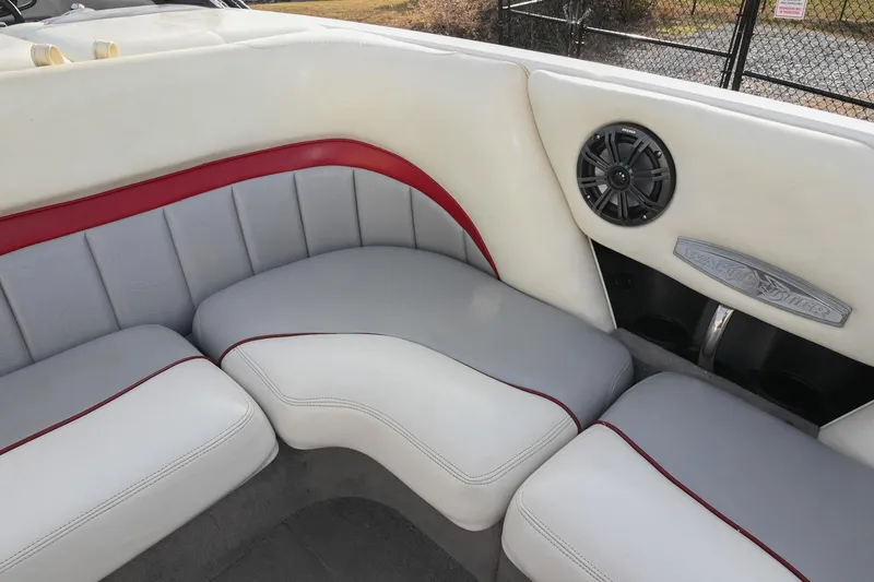 Slide: The Image of 2004 Malibu Wakesetter 23 XTi boat interior with white and red seating, speaker detail. - 19