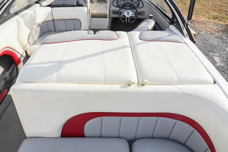 Slide: The Image of 2004 Malibu Wakesetter 23 XTi interior with white and red seating, steering wheel visible. - 21