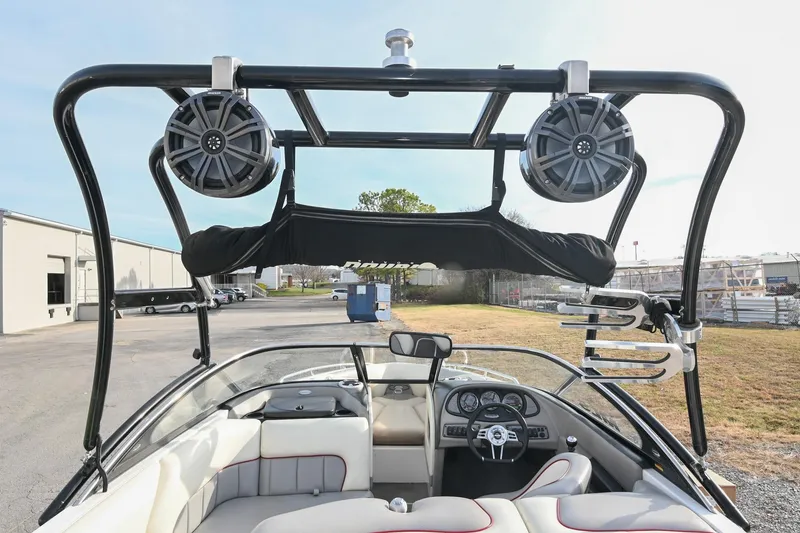 Slide: The Image of 2004 Malibu Wakesetter 23 XTi boat interior with speakers and wakeboard rack. - 23