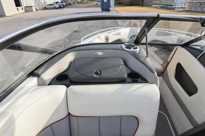 Slide: The Image of 2004 Malibu Wakesetter 23 XTi boat interior with seating and cup holders. - 27