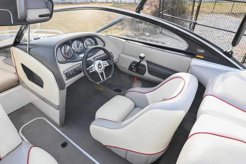 Slide: The Image of 2004 Malibu Wakesetter 23 XTi boat interior with steering wheel and dashboard. - 28