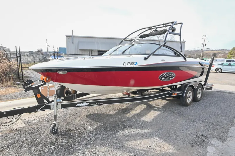 Slide: The Image of 2004 Malibu Wakesetter 23 XTi boat on trailer, red and black design. - 3
