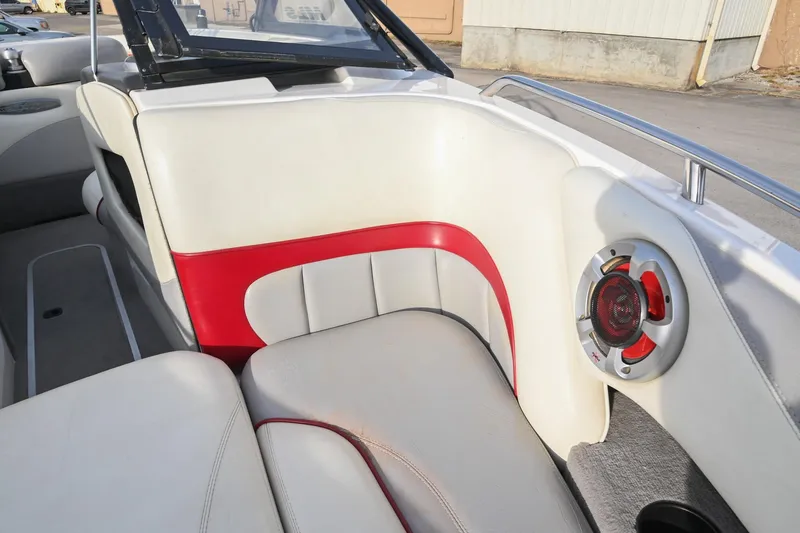 Slide: The Image of 2004 Malibu Wakesetter 23 XTi interior with red and white seating and speaker detail. - 38