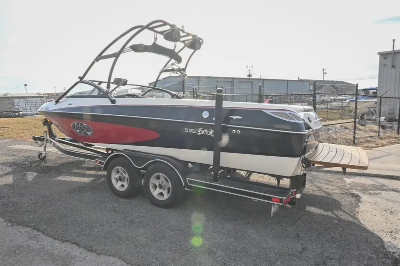 Slide: The Image of 2004 Malibu Wakesetter 23 XTi boat on trailer, parked outdoors. - 5