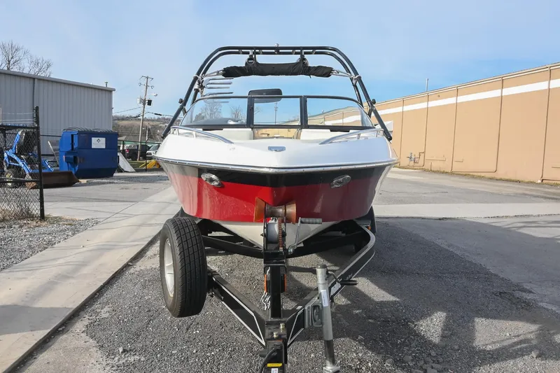 Slide: The Image of 2004 Malibu Wakesetter 23 XTi boat on trailer, parked outdoors. - 7