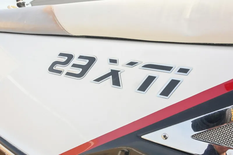 Slide: The Image of 2004 Malibu Wakesetter 23 XTi boat logo on white surface. - 9