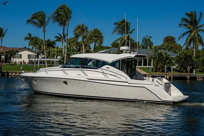 Slide: The Image of 2018 Tiara Yachts C39 Coupe cruising on a sunny day with palm trees in the background. - 11