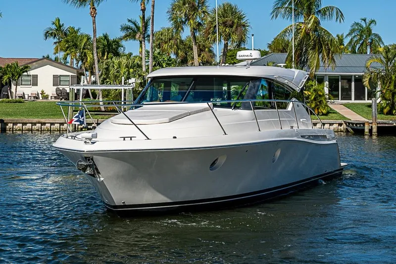 Slide: The Image of 2018 Tiara Yachts C39 Coupe cruising on a sunny day, surrounded by palm trees. - 15