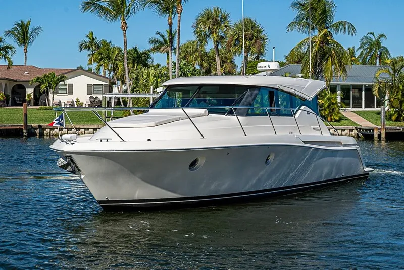 Slide: The Image of 2018 Tiara Yachts C39 Coupe cruising on a sunny day near palm trees. - 16