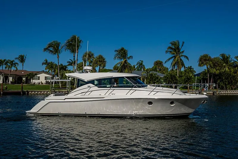 Slide: The Image of 2018 Tiara Yachts C39 Coupe cruising on a sunny day with palm trees in the background. - 21