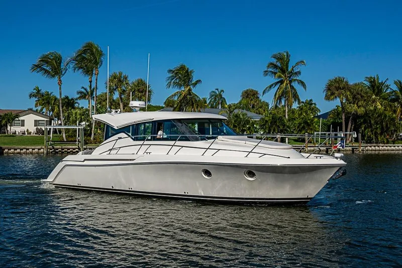 Slide: The Image of 2018 Tiara Yachts C39 Coupe cruising on a sunny day with palm trees in the background. - 23