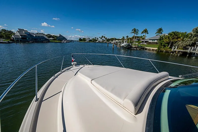 Slide: The Image of 2018 Tiara Yachts C39 Coupe cruising on a scenic waterway with palm trees. - 26
