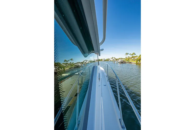 Slide: The Image of 2018 Tiara Yachts C39 Coupe on serene waterway with palm trees. - 27