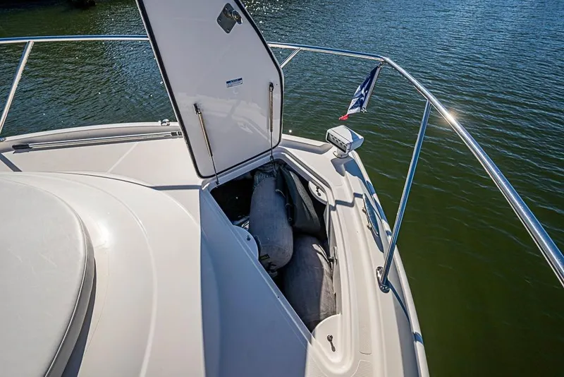 Slide: The Image of 2018 Tiara Yachts C39 Coupe bow storage compartment open on calm water. - 29