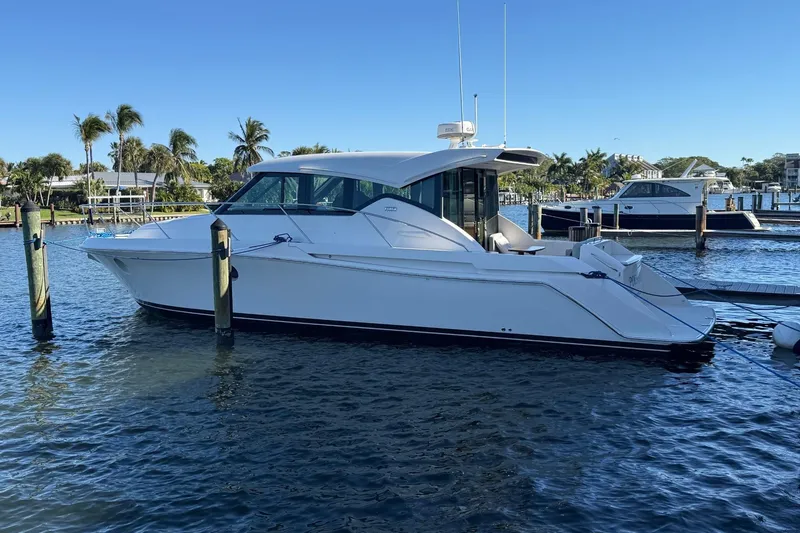 Slide: The Image of 2018 Tiara Yachts C39 Coupe cruising on a sunny day with palm trees in the background. - 3