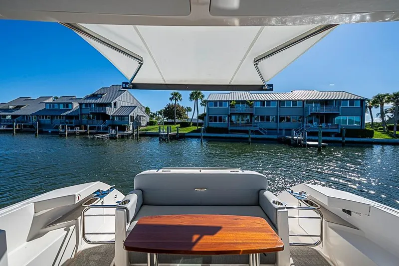 Slide: The Image of 2018 Tiara Yachts C39 Coupe, rear deck view, overlooking waterfront homes and calm waters. - 30