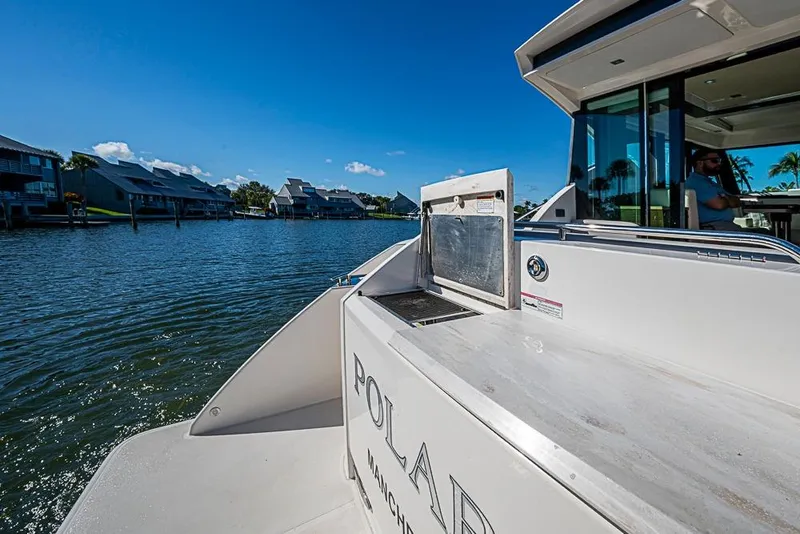 Slide: The Image of 2018 Tiara Yachts C39 Coupe on serene waterfront, showcasing luxury and style. - 33