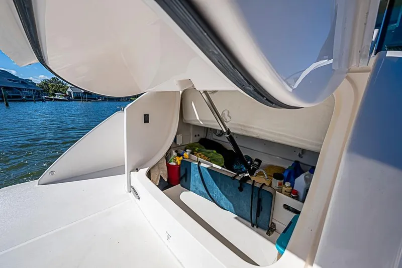 Slide: The Image of Storage compartment on 2018 Tiara Yachts C39 Coupe, open with various items inside. - 34