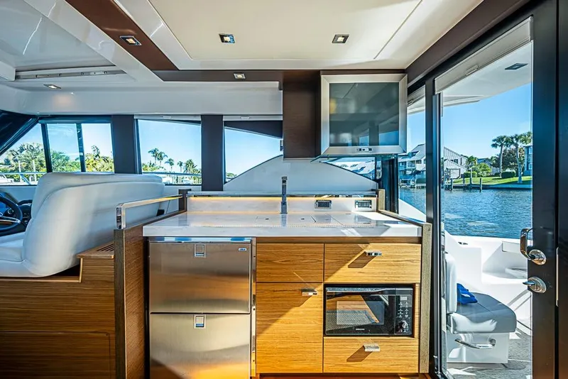 Slide: The Image of Luxurious interior of 2018 Tiara Yachts C39 Coupe with modern kitchen and scenic water view. - 36