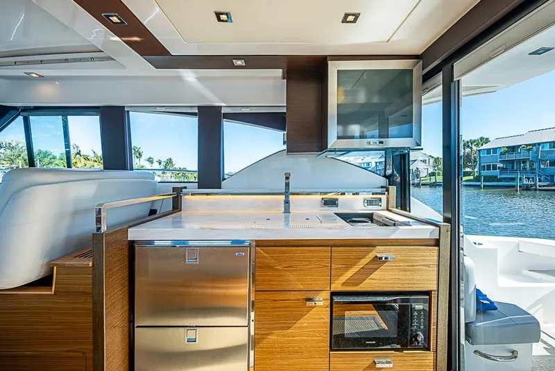 Slide: The Image of Interior of 2018 Tiara Yachts C39 Coupe, featuring modern kitchen with water view. - 37