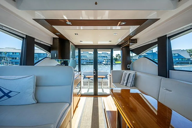 Slide: The Image of Interior of 2018 Tiara Yachts C39 Coupe with elegant seating and waterfront view. - 38