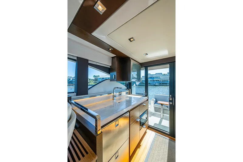 Slide: The Image of Interior of 2018 Tiara Yachts C39 Coupe, featuring modern kitchen and outdoor view. - 39
