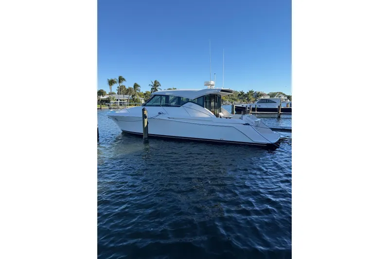 Slide: The Image of 2018 Tiara Yachts C39 Coupe on water, rear view, tropical setting. - 4