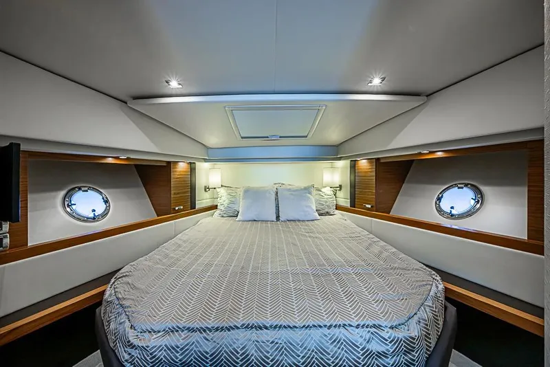 Slide: The Image of Luxurious 2018 Tiara Yachts C39 Coupe cabin interior with elegant bedding and porthole windows. - 50