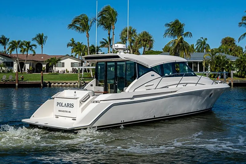 Slide: The Image of 2018 Tiara Yachts C39 Coupe cruising on a sunny day near waterfront homes. - 6