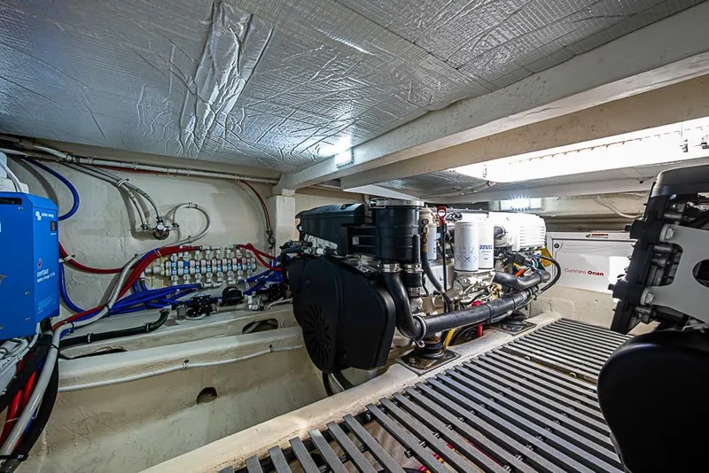 Slide: The Image of Engine room of 2018 Tiara Yachts C39 Coupe, featuring Cummins Onan generator and wiring. - 63