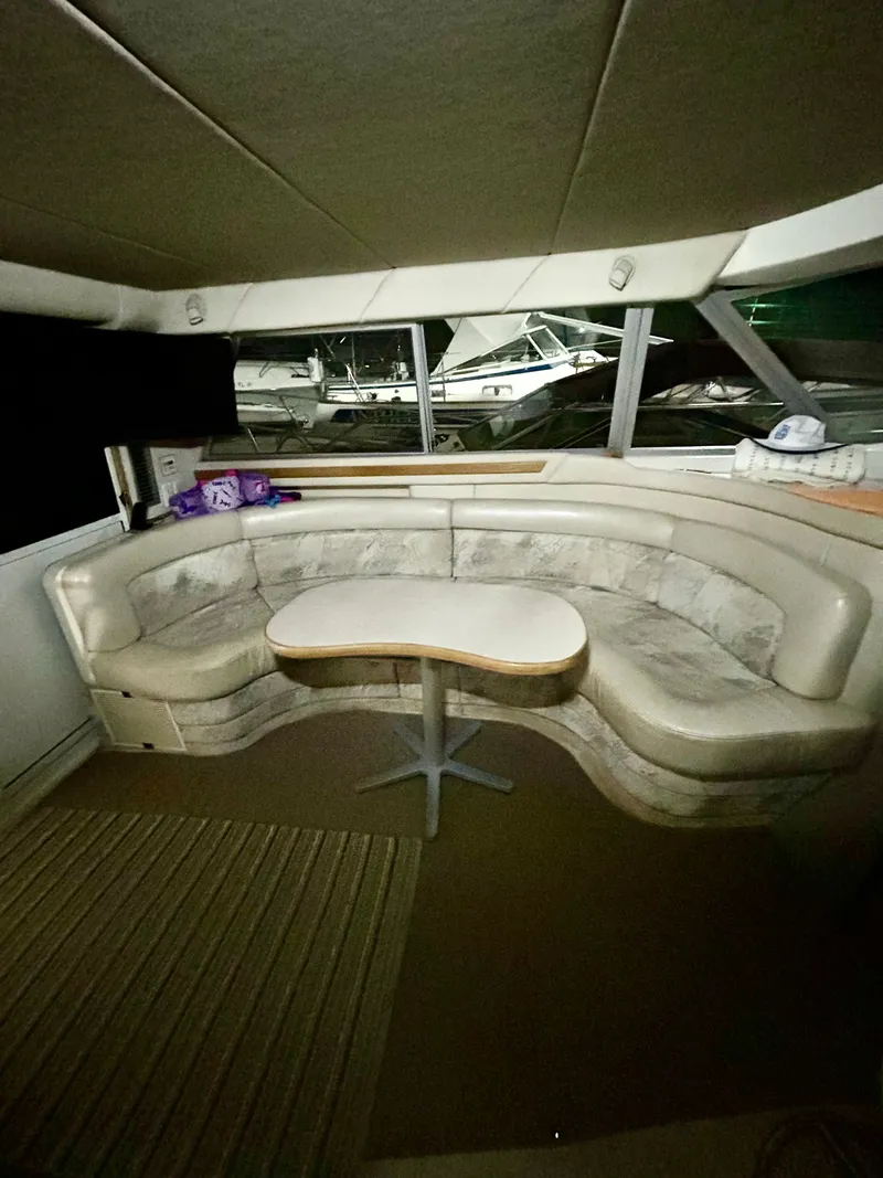 Slide: The Image of Interior of a 1996 Sea Ray 370 Sedan Bridge with seating area. - 10