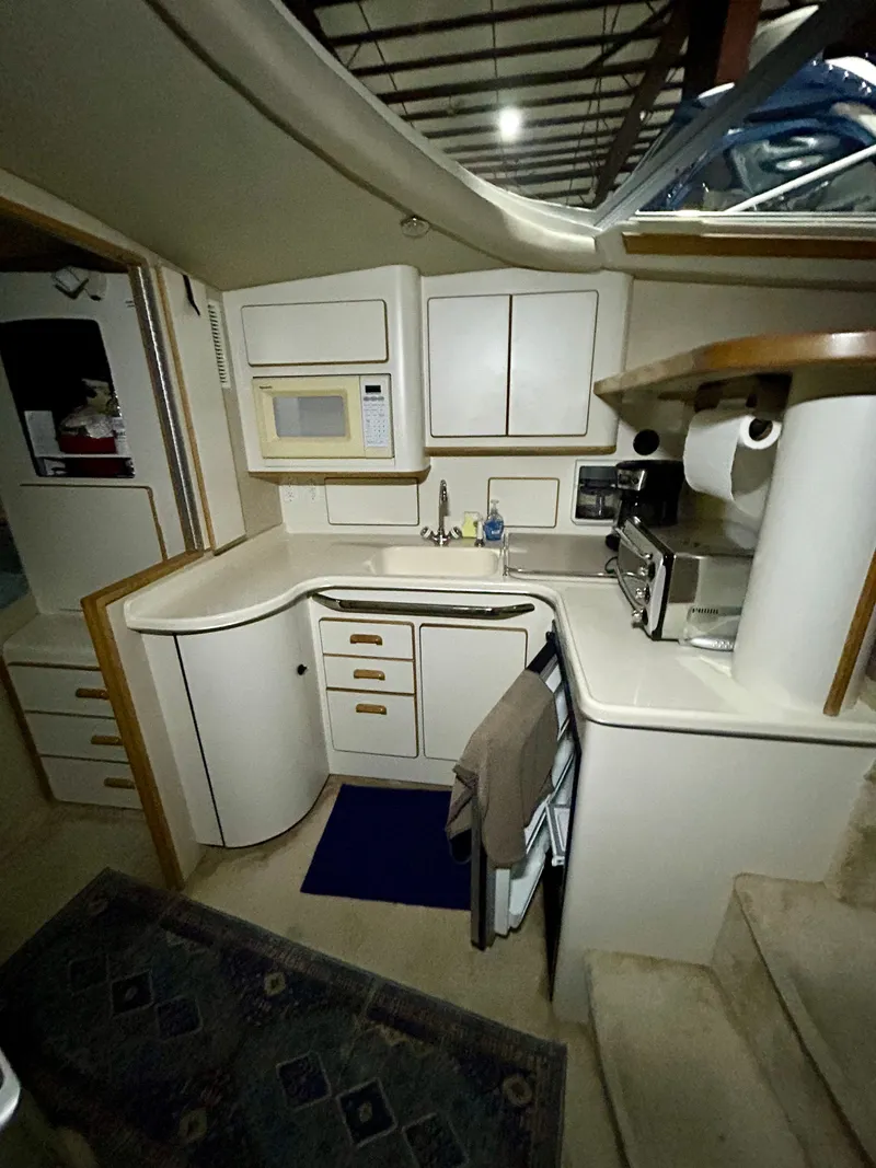 Slide: The Image of Interior of 1996 Sea Ray 370 Sedan Bridge, compact kitchen area. - 13