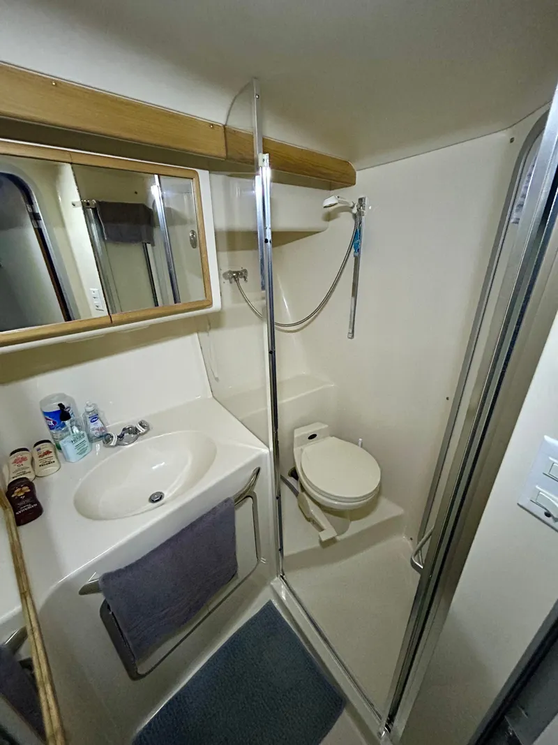 Slide: The Image of 1996 Sea Ray 370 Sedan Bridge bathroom with shower and toilet. - 17