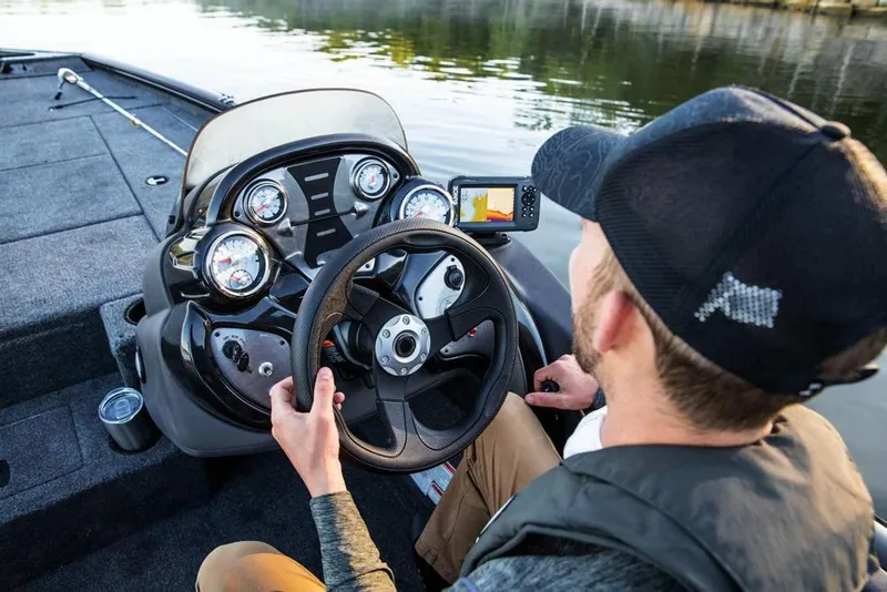 Slide: The Image of Indoor showroom displaying multiple Tracker Pro Team 195 TXW boats, 2020 model. - 10