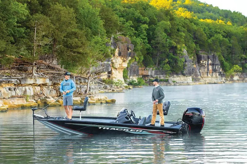 Slide: The Image of 2020 Tracker Pro Team 195 TXW boat with outboard motor in parking lot. - 5