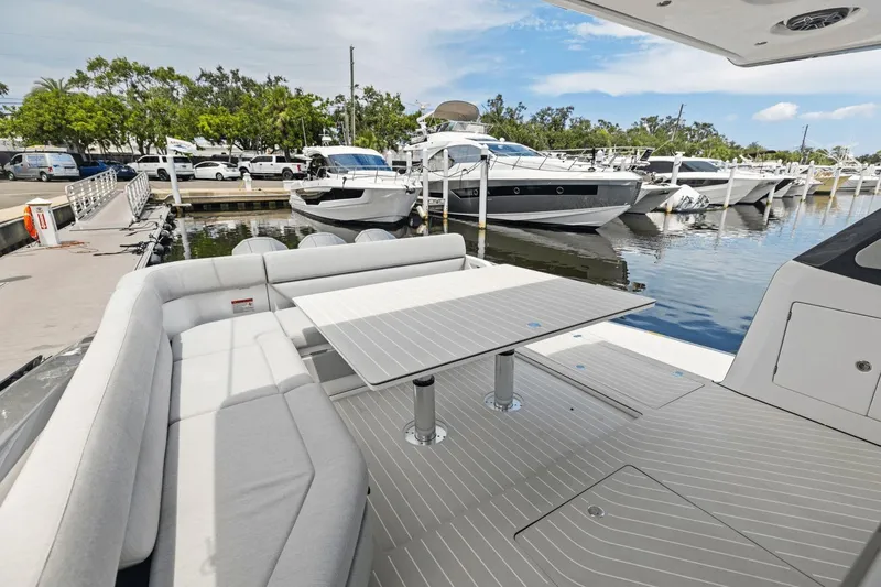 Slide: The Image of Luxurious 2026 Azimut Verve 48 yacht interior with sleek seating and table at marina. - 12