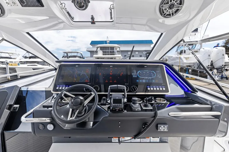Slide: The Image of Helm of 2026 Azimut Verve 48 yacht with advanced navigation displays and controls. - 21