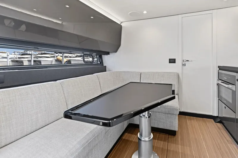 Slide: The Image of Interior of 2026 Azimut Verve 48 yacht with modern seating and sleek table design. - 27