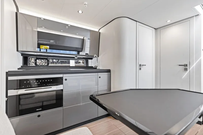 Slide: The Image of Modern kitchen interior of 2026 Azimut Verve 48 yacht, featuring sleek cabinetry and appliances. - 33