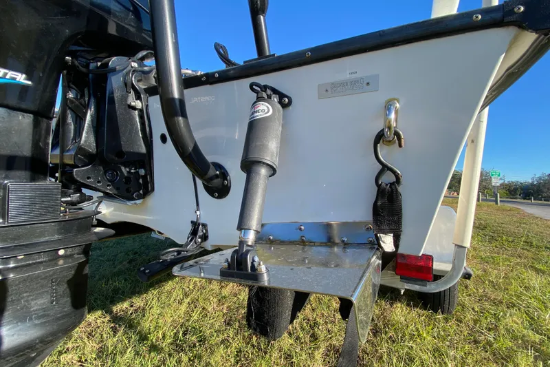 Slide: The Image of 1999 Silver King Signature 16 boat on trailer, featuring Mercury engine, under clear blue sky. - 14