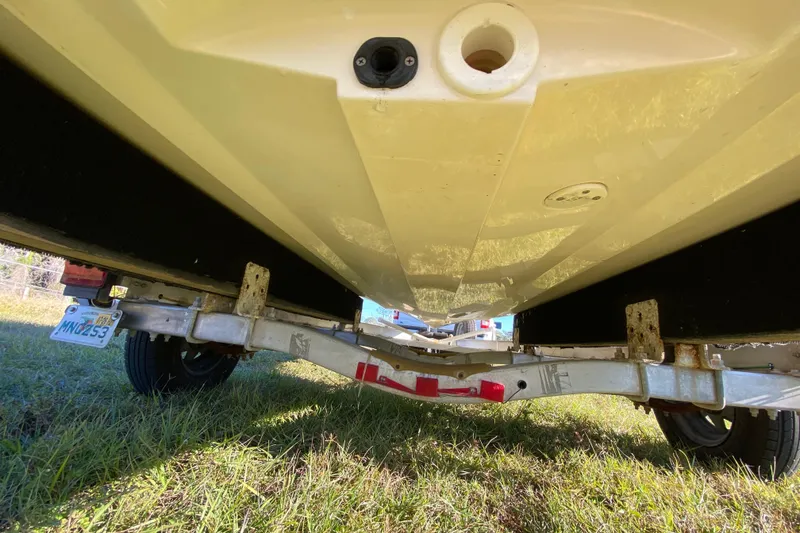 Slide: The Image of 1999 Silver King Signature 16 boat logo on white hull, grassy background. - 15