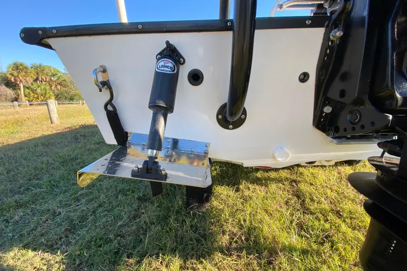 Slide: The Image of 1999 Silver King Signature 16 boat on grassy area, showcasing deck and seating. - 16